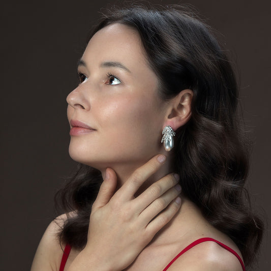 Model wearing Rawan Kanan handcrafted matte 925 sterling silver drop earrings with organic textured crown.