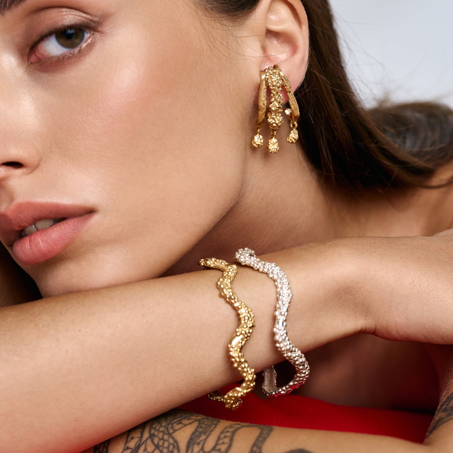Minimalist stacked textured cuffs in sterling silver and 14k gold by Rawan Kanan."