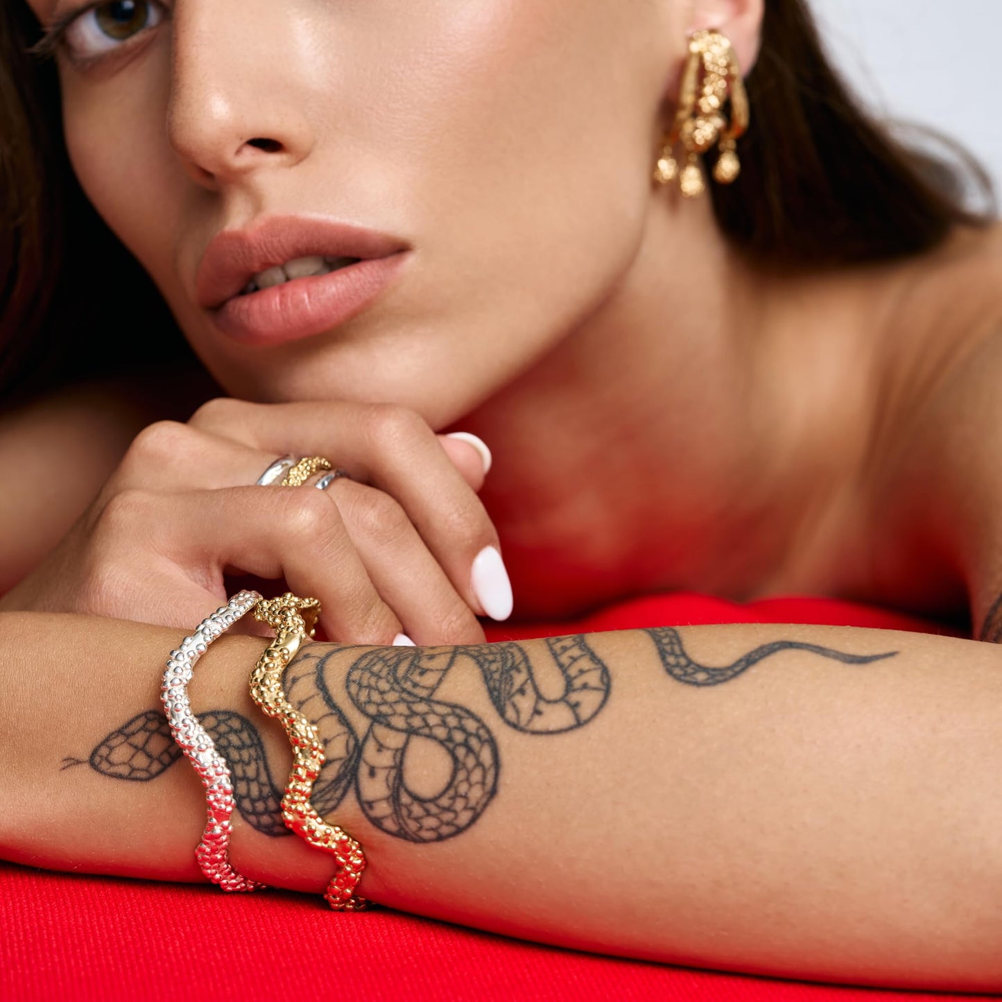 Model wearing Rawan Kanan handcrafted triple branch statement earrings in 14K gold plated silver.