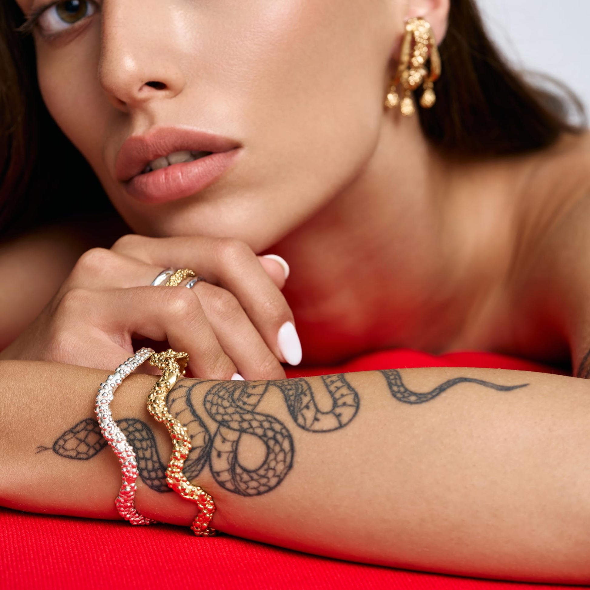 Model wearing Rawan Kanan handcrafted triple branch statement earrings in 14K gold plated silver.