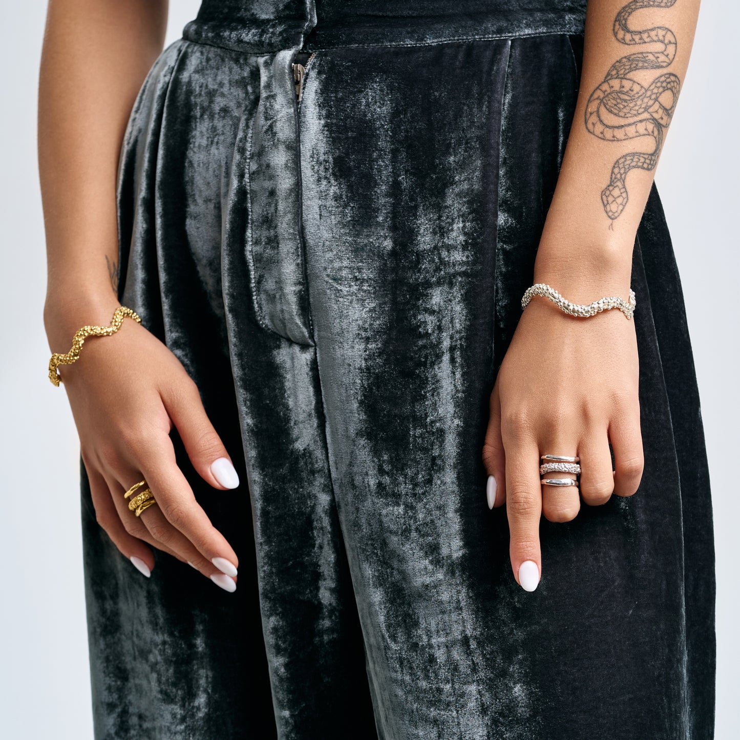 Minimalist stacked textured cuffs in sterling silver and 14k gold by Rawan Kanan."